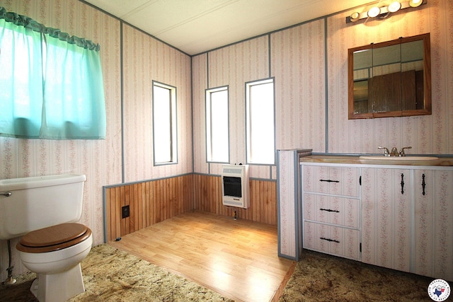 334 Pine Valley Rd, Texarkana, TX 75501 - bathroom with heating unit, wallpapered walls, wood finished floors, vanity, and wainscoting