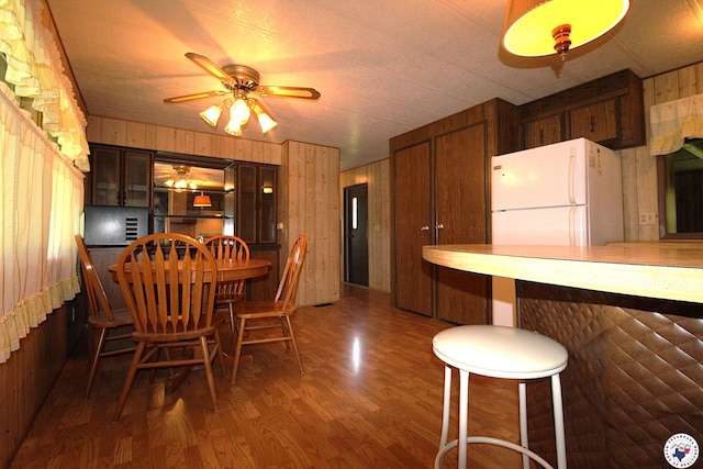 334 Pine Valley Rd, Texarkana, TX 75501 - dining area with dark wood-style flooring, wood walls, and a ceiling fan