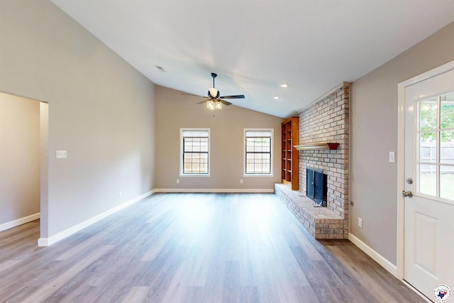 403 Edgewood Ln, Wake Village, TX 75501 - unfurnished living room featuring a ceiling fan, a fireplace, vaulted ceiling, wood finished floors, and baseboards