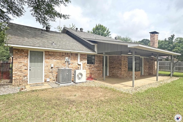 403 Edgewood Ln, Wake Village, TX 75501 - back of house with central air condition unit, a chimney, ac unit, a patio, and roof with shingles