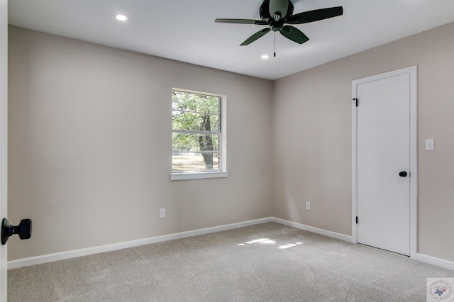 unfurnished room with ceiling fan and light colored carpet