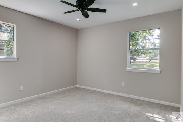 unfurnished room featuring ceiling fan and light colored carpet