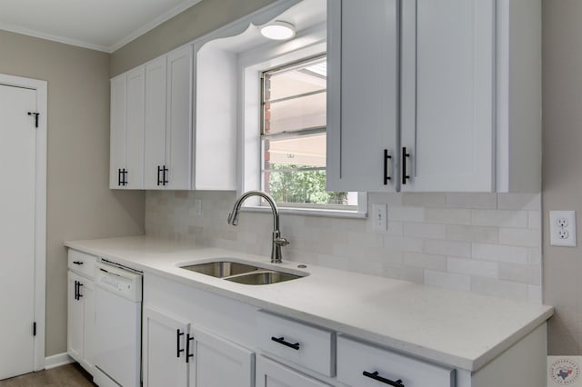 kitchen featuring crown molding, tasteful backsplash, dishwasher, sink, and white cabinets