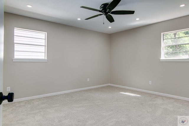 carpeted empty room featuring ceiling fan