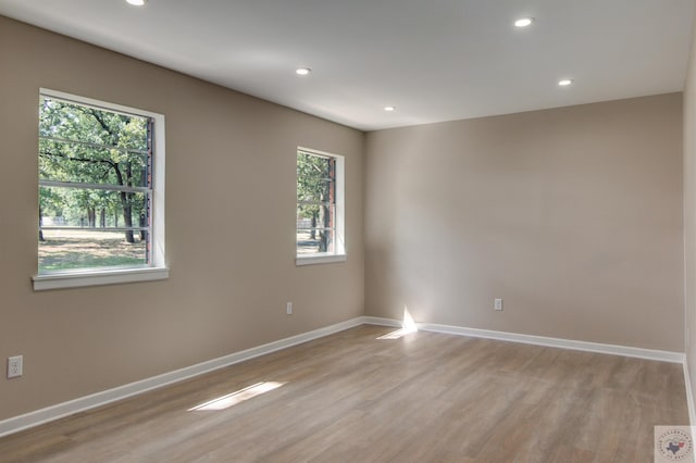 unfurnished room with light hardwood / wood-style floors and a wealth of natural light