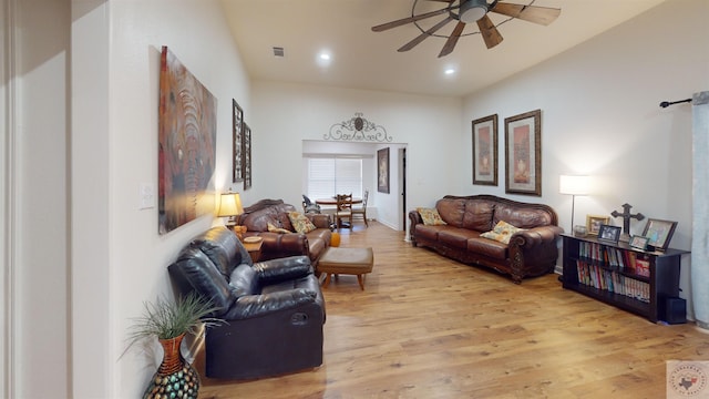 living room with ceiling fan and light hardwood / wood-style floors