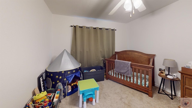 bedroom featuring light colored carpet and ceiling fan