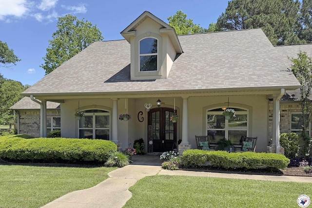220 Quail Trl, Texarkana, TX 75501 - view of front of home with french doors, covered porch, stucco siding, roof with shingles, and a front lawn