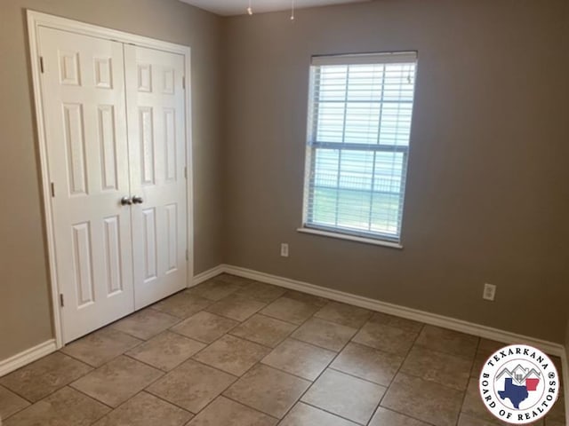 2415-2417 Laurel, Texarkana, AR 71854 - unfurnished bedroom with multiple windows, a closet, and baseboards