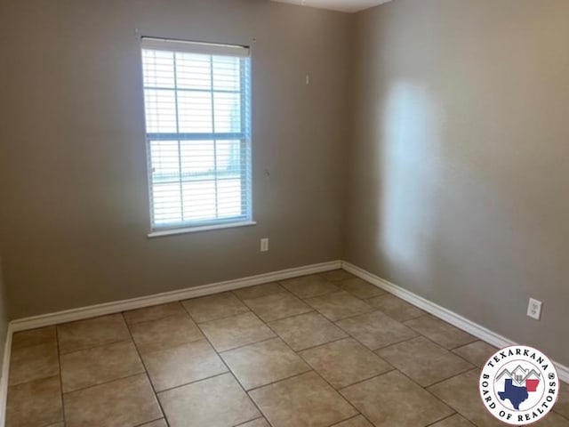 2415-2417 Laurel, Texarkana, AR 71854 - empty room featuring healthy amount of natural light, light tile patterned floors, and baseboards