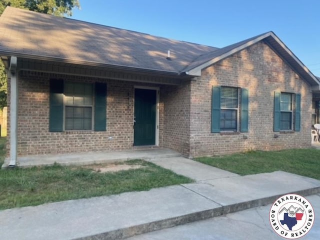 2415-2417 Laurel, Texarkana, AR 71854 - single story home featuring brick siding, a shingled roof, and a front lawn