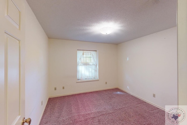 carpeted empty room with a textured ceiling