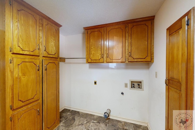 clothes washing area with a textured ceiling, washer hookup, hookup for a gas dryer, hookup for an electric dryer, and cabinets