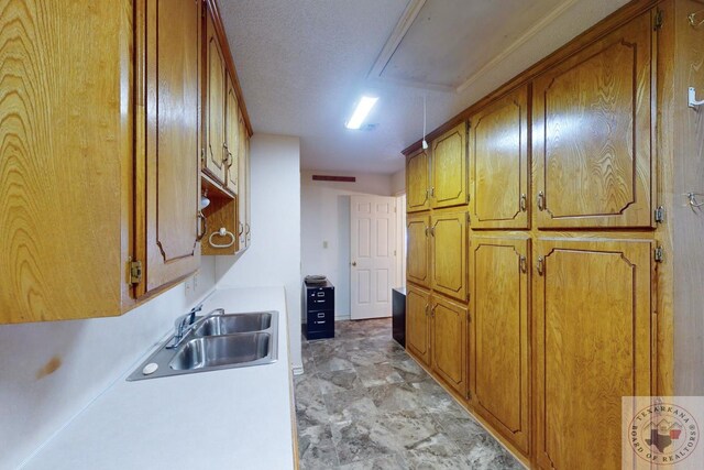 kitchen with sink and a textured ceiling