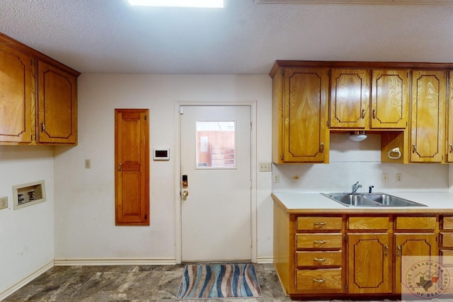 kitchen featuring sink and a textured ceiling