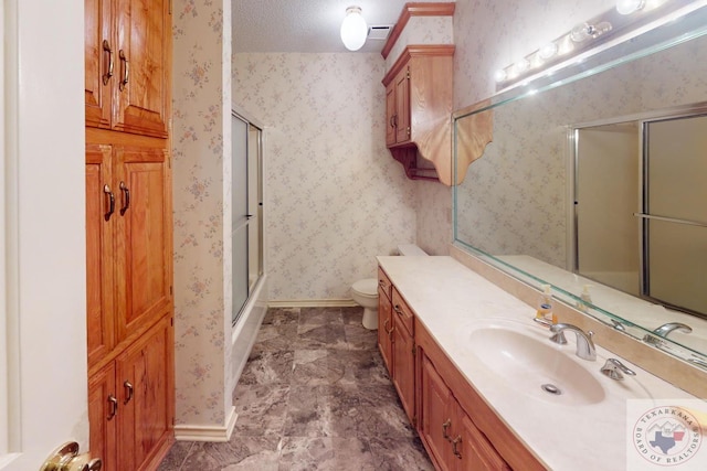 bathroom featuring vanity, toilet, and a textured ceiling