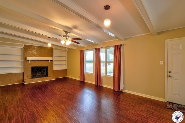 4101 Columbia Ave, Texarkana, TX 75503 - unfurnished living room featuring beamed ceiling, a ceiling fan, baseboards, a brick fireplace, and dark wood-style floors