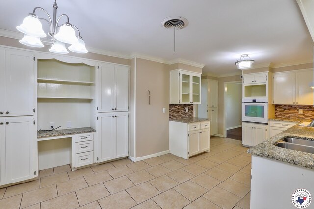 4101 Columbia Ave, Texarkana, TX 75503 - kitchen featuring oven, open shelves, decorative backsplash, a sink, and crown molding