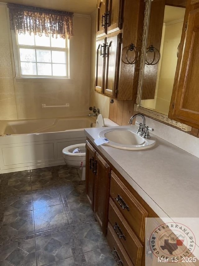 bathroom featuring toilet, a tub to relax in, and vanity