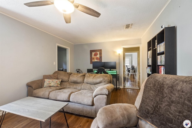 1324 Linden Ave, Texarkana, AR 71854 - living room featuring wood finished floors, a textured ceiling, ceiling fan, ornamental molding, and a desk