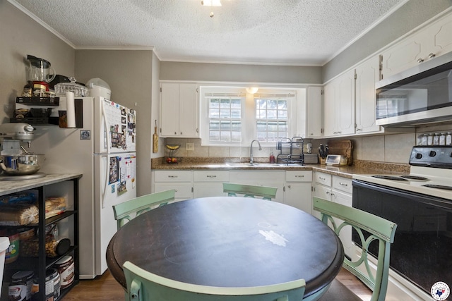 1324 Linden Ave, Texarkana, AR 71854 - kitchen with white appliances, a textured ceiling, white cabinetry, decorative backsplash, and dark wood-style floors