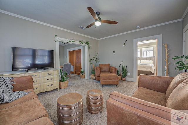 living room with ceiling fan and ornamental molding