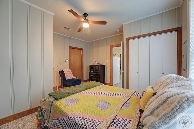 carpeted bedroom with ceiling fan and crown molding