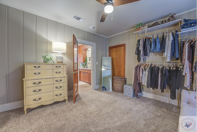 spacious closet featuring ceiling fan and light colored carpet