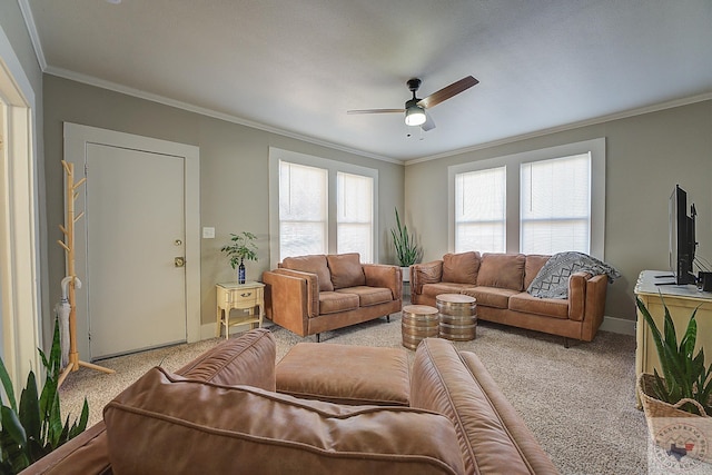 carpeted living room with ceiling fan and ornamental molding