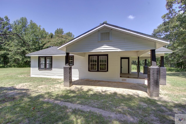 view of front of home with a porch and a front lawn