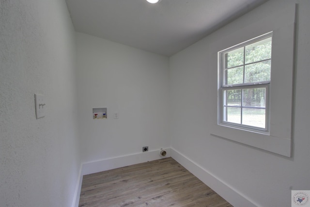 laundry area featuring hookup for an electric dryer, washer hookup, and light hardwood / wood-style flooring