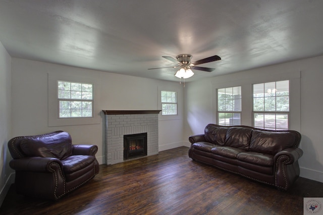 living room with ceiling fan, a fireplace, and dark hardwood / wood-style flooring