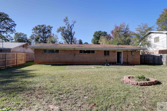 back of property featuring a lawn