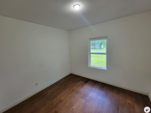 121 Circle Dr, Bogata, TX 75417 - spare room with dark wood-style flooring and baseboards