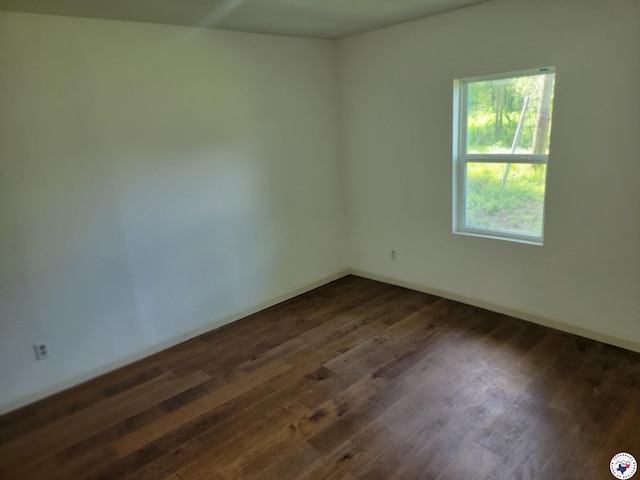 121 Circle Dr, Bogata, TX 75417 - unfurnished room featuring dark wood-style floors and baseboards