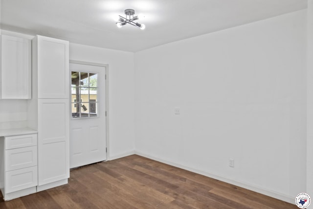 121 Circle Dr, Bogata, TX 75417 - unfurnished dining area featuring dark wood-style flooring and baseboards