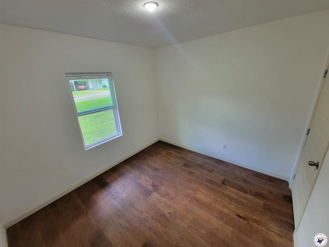 121 Circle Dr, Bogata, TX 75417 - empty room with dark wood-style floors and baseboards