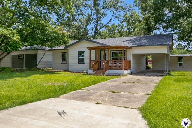 121 Circle Dr, Bogata, TX 75417 - ranch-style home with driveway, a front yard, and a carport