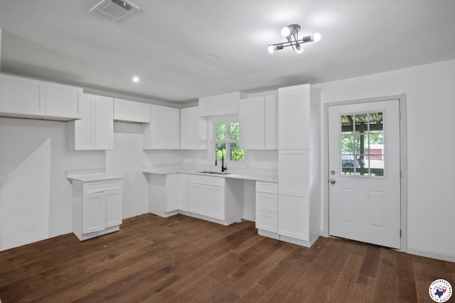 121 Circle Dr, Bogata, TX 75417 - kitchen featuring dark wood-style floors, white cabinets, light countertops, and recessed lighting
