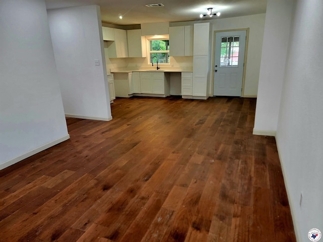 121 Circle Dr, Bogata, TX 75417 - kitchen with light countertops, dark wood-style floors, and white cabinets