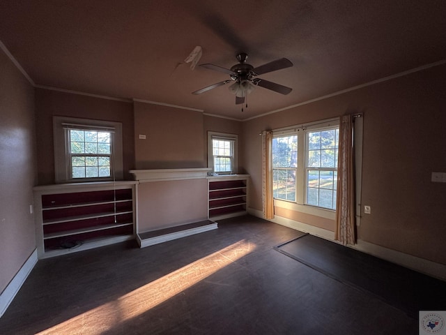 unfurnished room featuring ceiling fan and crown molding