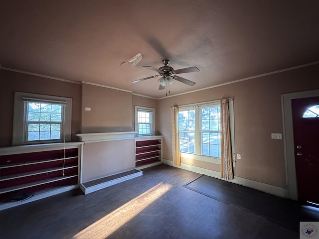 foyer entrance featuring ceiling fan, dark wood-type flooring, and ornamental molding