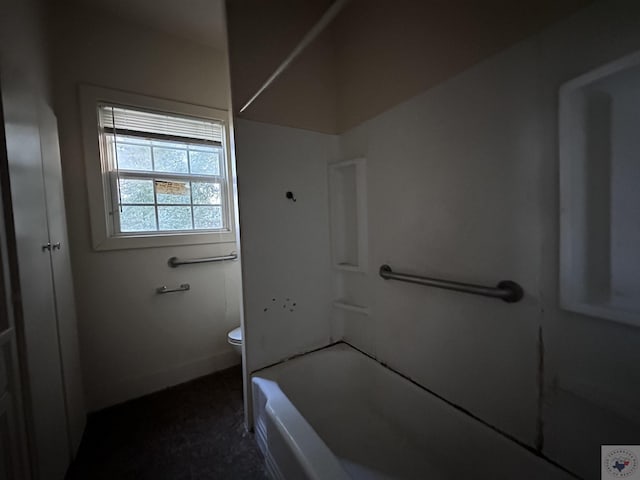 bathroom with toilet and washtub / shower combination