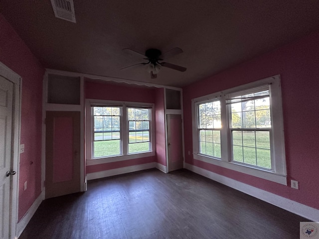 unfurnished room featuring ceiling fan and dark hardwood / wood-style floors