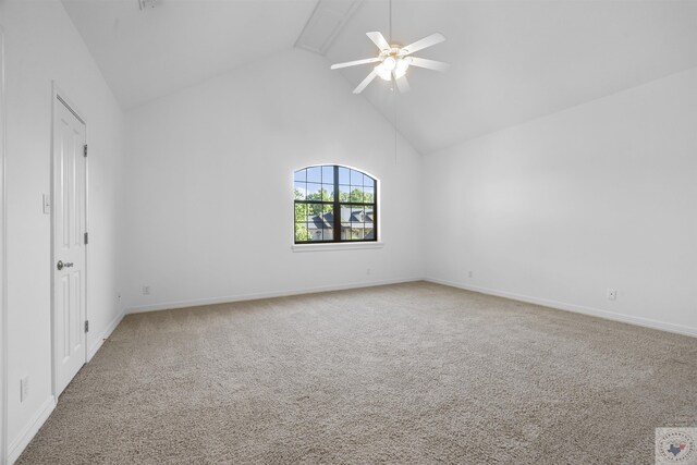 spare room featuring baseboards, ceiling fan, high vaulted ceiling, and carpet flooring