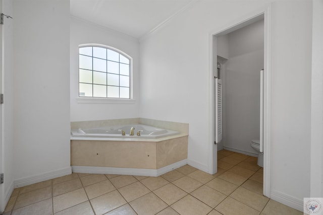 bathroom featuring tile patterned flooring, toilet, baseboards, ornamental molding, and a bath