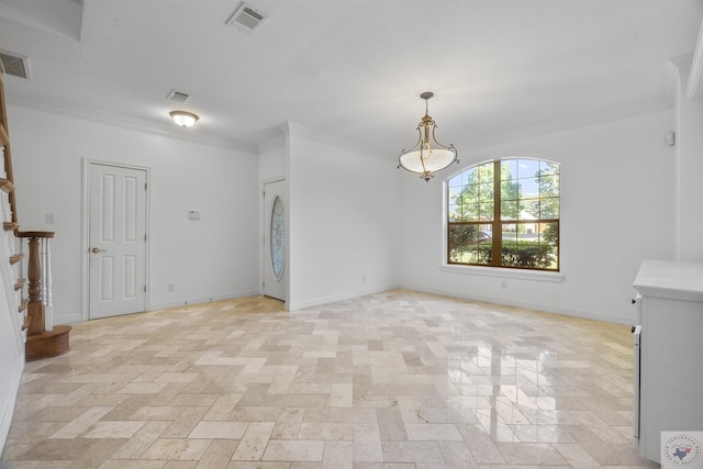 spare room with baseboards, visible vents, and ornamental molding