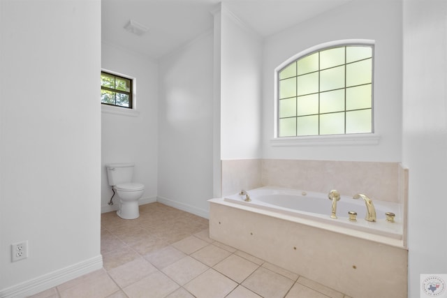 bathroom featuring toilet, a tub to relax in, and tile patterned floors