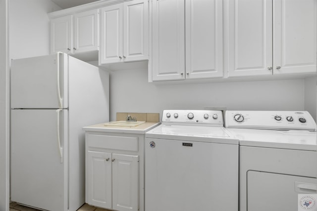 laundry room with independent washer and dryer and a sink