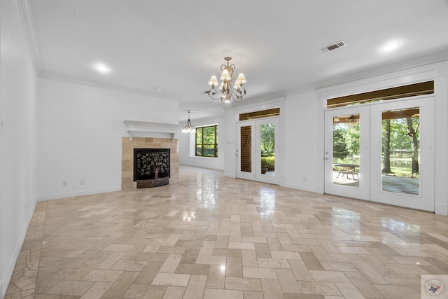 unfurnished living room with visible vents, ornamental molding, a notable chandelier, and french doors